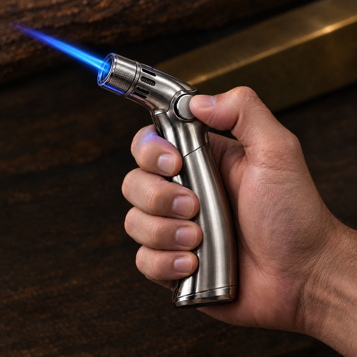 The windproof torch lighter held in one hand, firing a single hard blue jet