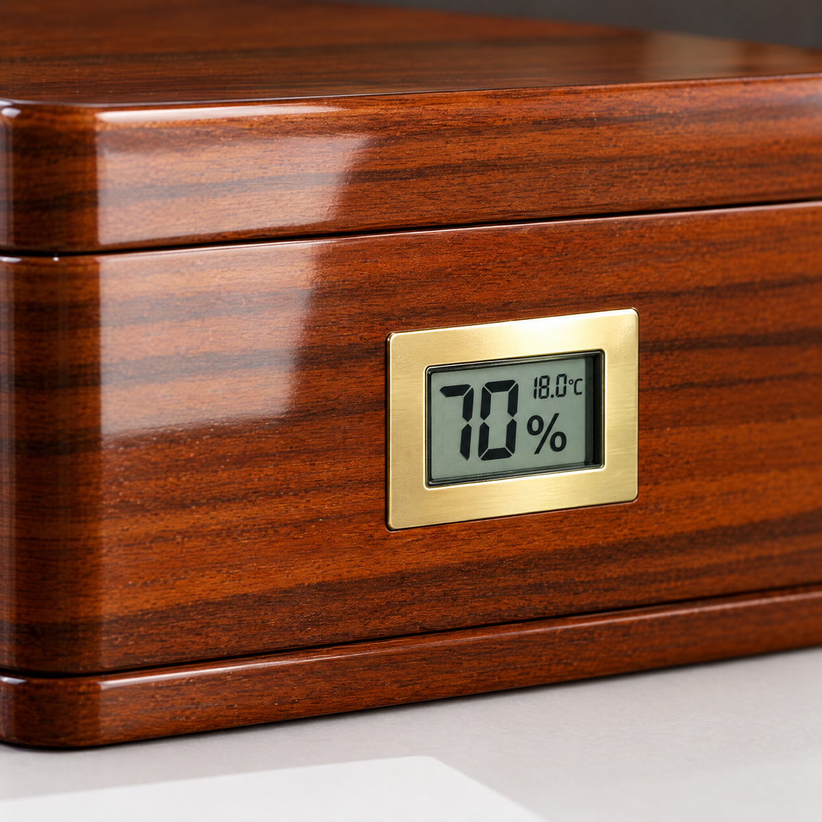 Macro detail of the digital hygrometer set into the piano-lacquer front face
