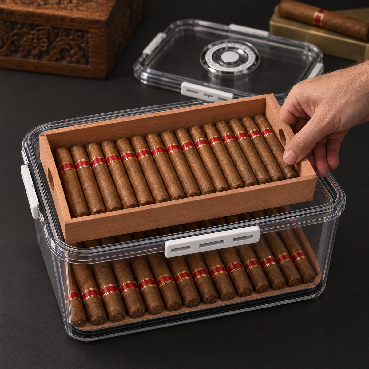 Hand lifting the removable cedar tray out of the box to reveal the lower layer of cigars