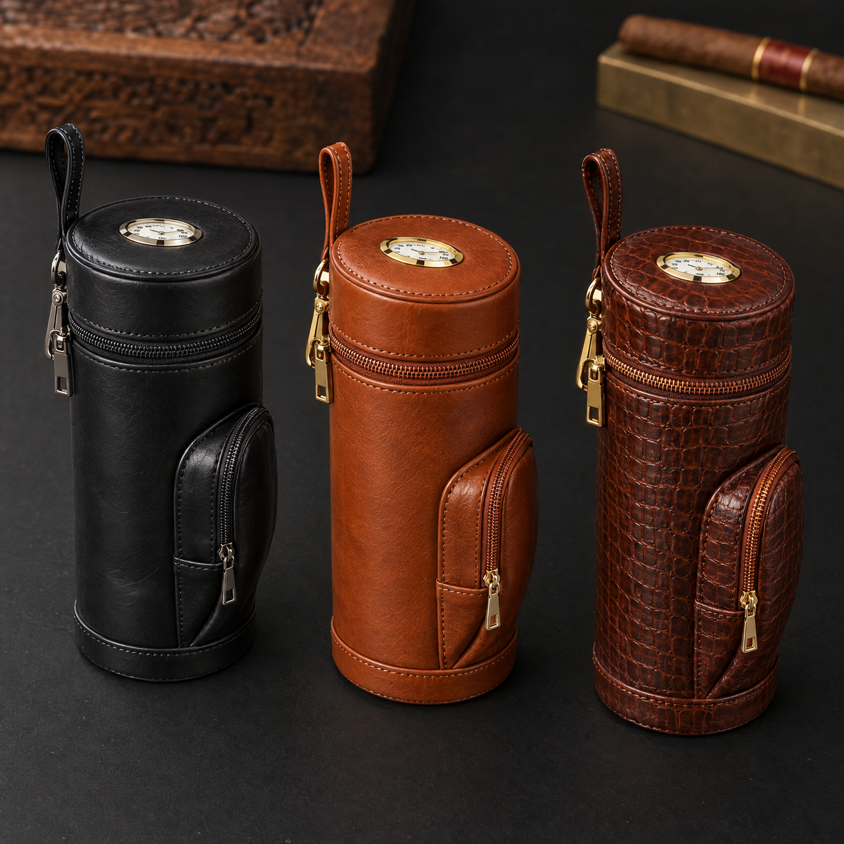 The travel case in its three finishes side by side: black, tan and crocodile-embossed brown