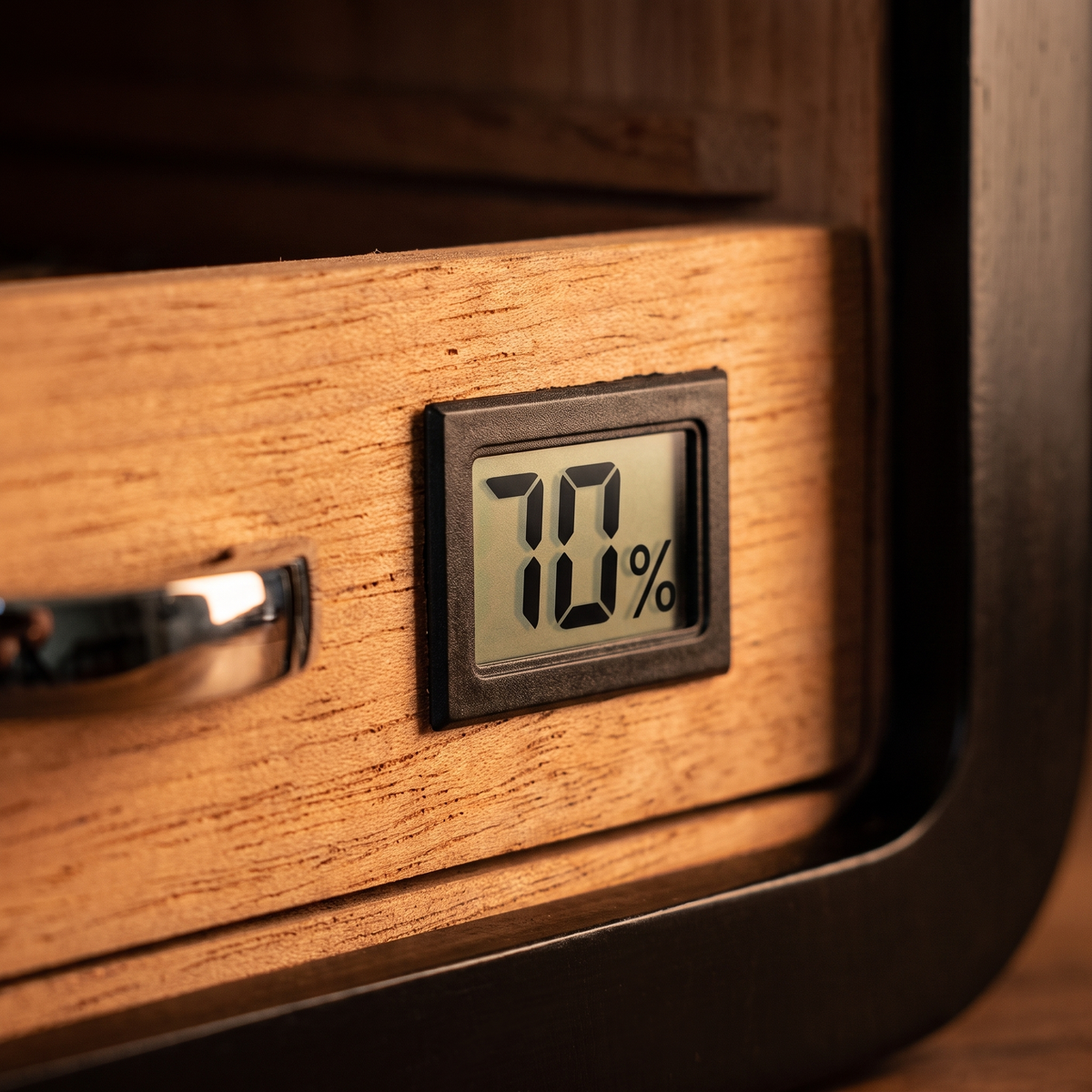 Vitrine Reserve — digital hygrometer detail (~70% RH)